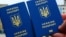 Generic – Two Ukrainian passports in front of Brandenburg Gate in Berlin, Germany. Travel concept