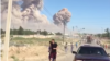 Kazakhstan - People trying to leave Arys on the background of a cloud of smoke from exploding ammunition. Turkestan region, 24Jun2019.