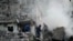 Rescuers extinguish a fire and work in a damaged residential building  following missile strikes on the Ukrainian capital of Kyiv on July 2, 2026, amid the Russian invasion of Ukraine.