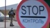 Ukrainian servicemen standing guard at the Mayorske checkpoint in Donetsk region, eastern Ukraine