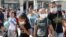UKRAINE -- CRIMEA, SEPTEMBER 4, 2018: Local residents and their children wear face masks as they wait for buses in Armyansk, north Crimea, where high concentrations of sulphur dioxide have been confirmed following a sudden release of vapours of a toxic ag