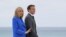 French President Emmanuel Macron and his wife Brigitte Macron arrive to pose for photos with British Prime Minister Boris Johnson and his wife Carrie Johnson at the G-7 summit, in Carbis Bay, Cornwall, Britain June 11, 2021.