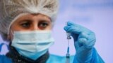 UKRAINE -- A medical worker fills a syringe with the Oxford University/AstraZeneca vaccine against the coronavirus disease (COVID-19), which is produced in India and marketed as Covishield, in Kyiv, March 16, 2021