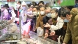 Customers wearing face masks shop inside a supermarket following an outbreak of the novel coronavirus in Wuhan, Hubei province, China February 10, 2020. China Daily via REUTERS ATTENTION EDITORS - THIS IMAGE WAS PROVIDED BY A THIRD PARTY. CHINA OUT. - RC