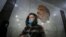 RUSSIA -- An elderly woman wearing a protective face mask walks in Moscow's Metro during the pandemic of SARS-CoV-2 coronavirus in Moscow, March 9, 2021