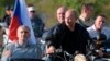 Президент России Путин катался на мотоцикле в аннексированном Крыму, пока в Москве шла крупнейшая за годы акция протеста