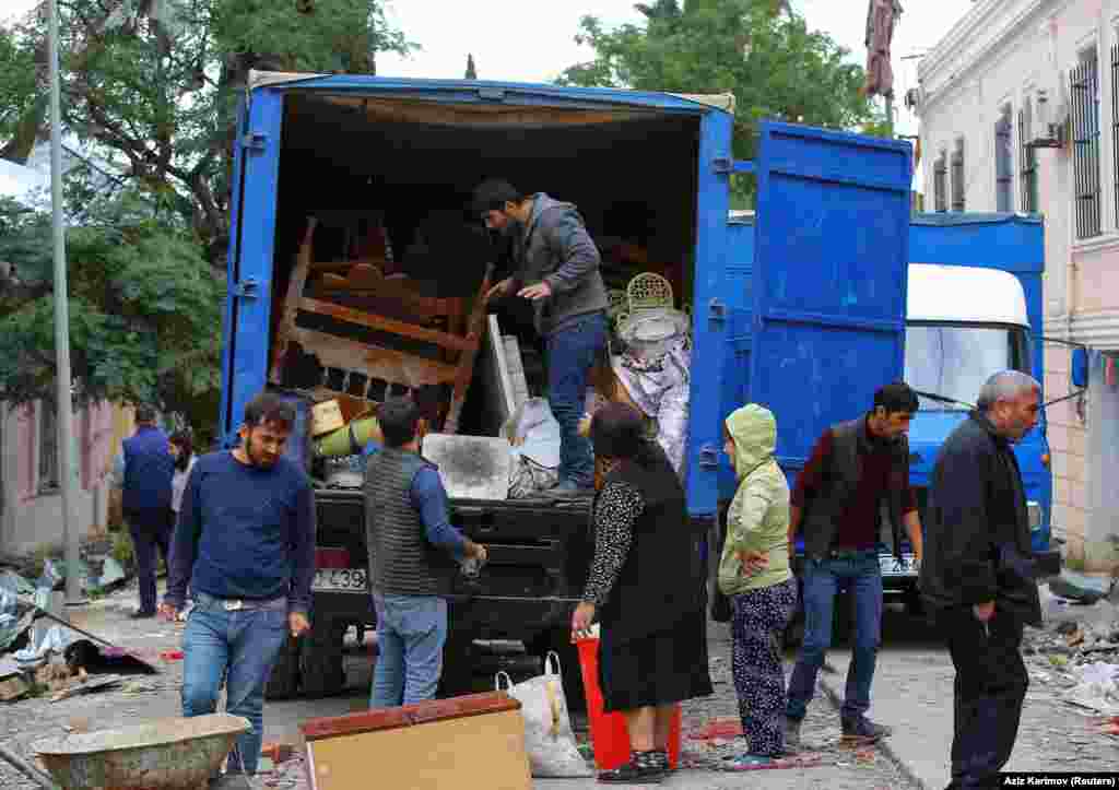 Azerbaijanis in the city of Ganja load belongings into a truck next to a house damaged by recent shelling. For many, this is a familiar scene: During the 1988-1994 conflict over Nagorno-Karabakh, some 1 million people, both ethnic Azerbaijanis and ethnic Armenians, were forced to leave their homes in Karabakh and elsewhere in Azerbaijan as well as Armenia. Many of these displaced Azerbaijani migrants now live in Ganja.&nbsp;