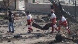 IRAN -- Members of the International Red Crescent collect bodies of victims around the wreckage after an Ukraine International Airlines Boeing 737-800 carrying 176 people crashed near Imam Khomeini Airport in Tehran, killing everyone on board, in Shahriar