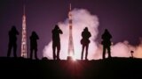 Baikonur Cosmodrome, Kazakhstan - Soyuz MS-12 / Photographers take pictures as the Soyuz MS-12 spacecraft carrying the crew formed of Aleksey Ovchinin of Russia, Nick Hague and Christina Koch of the U.S. blasts off to the International Space Station (ISS)