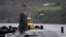 FILE PHOTO: Crew from HMS Vengeance stand on their vessel as they return along the Clyde river to the Faslane naval base near Glasgow