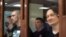 RUSSIA -- Maksim Umetbayev and Igor Lyakhovets (L-R front), former officers of Moscow's Western District Police Department, charged with framing journalist Ivan Golunov, attend the announcement of the verdict at the Moscow City Court, May 28, 2021