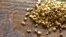 a mound of gold on a old wooden work table