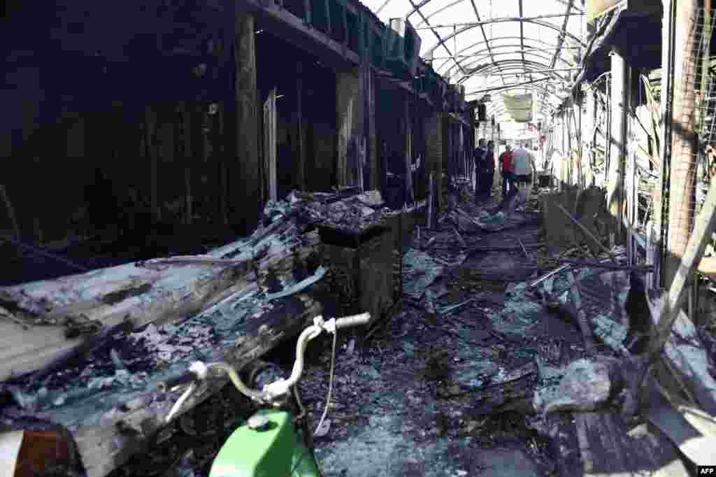 Ukraine -- People walk in a market gallery destroyed by shelling, in the Kievsky district in Donetsk, September 15, 2014