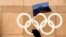SWITZERLAND --A supporter waves a Russian flag in front of the logo of the International Olympic Committee (IOC) at their headquarter, in Pully near Lausanne, December 5, 2017