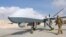 AFGHANISTAN -- A U.S. Air Force officer passes in front of a MQ-9 Reaper drone, one of a squadron that has arrived to step up the fight against the Taliban, at the Kandahar air base, January 23, 2018