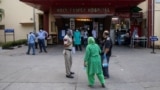 Relatives of a patient who is suffering from the coronavirus disease (COVID-19), argue with a police officer to admit him to the emergency ward at Holy Family Hospital in New Delhi, India, May 1, 2021.