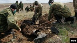 Добровольцы эксгумируют останки бойца Вооруженных сил Украины, погибших во время боев за Дебальцево