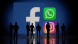Small toy figures are seen in front of displayed Facebook, Whatsapp and Instagram logos in this illustration taken October 4, 2021.