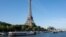 A peniche boat sails past the Eiffel Tower on the River Seine on July 17, 2023, during a parade to test "maneuvers", "distances", "duration" and "video capture" of the future opening ceremony of the Paris Olympics in 2024.