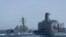 This US Navy handout photograph released on May 2, 2026 by US Central Command Public Affairs shows Arleigh Burke-class guided-missile USS Michael Murphy (DDG 112) conducting a replenishment-at-sea with fleet replenishment oiler USNS Henry J. Kaiser (T-AO-