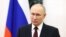 In this pool photograph distributed by Russian state agency Sputnik on February 27, 2024, Russia's President Vladimir Putin makes a video address to congratulate the military personnel and veterans of the Special Operations Forces, a branch of the Armed F