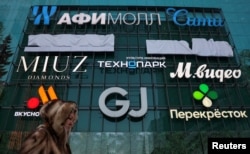 Женщина у торгового центра в Москве-Сити, 17 февраля 2026 года, фото Reuters