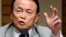 Japan -- Japan's Finance and Deputy Prime Minister Taro Aso gestures as he delivers a speech in Tokyo on June 28, 2013. 