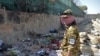 Боец "Талибана" охраняет место взрыва двух террористов-смертников в аэропорту Кабула, 27 августа 2021 года