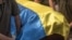 Ukrainian soldiers carry a coffin, covered with the national flag, of a Ukrainian serviceman Yurii Yurchenko, who was killed fighting Russian troops in the Lugansk region, during the funeral service at the Saint Michael's Golden-Domed Monastery in Kyiv, o