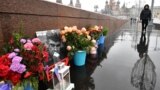 RUSSIA -- People lay flowers at the site where late opposition leader Boris Nemtsov was fatally shot on a bridge near the Kremlin, in central Moscow, February 27, 2020