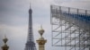 This picture shows stands at the construction site of La Concorde Urban Parc site for the upcoming Paris 2024 Olympic Games, with the Eiffel Tower in the background, on April 26, 2024 in central Paris.