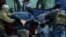 BELARUS -- Law enforcement officers detain two men as opposition supporters rally to protest against police violence and the Belarus presidential election results in Minsk, November 29, 2020