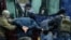 BELARUS -- Law enforcement officers detain two men as opposition supporters rally to protest against police violence and the Belarus presidential election results in Minsk, November 29, 2020