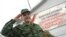 Russia -- Conscript salutes at an enlistment office in Omsk. The placard says: "Compulsory military service is Russian citizen's constitutional duty", 28Apr2008