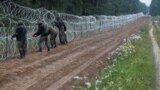 Poland -- Polish soldiers build a fence on the border between Poland and Belarus near the village of Nomiki, Poland August 26, 2021