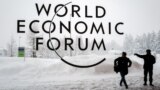 SWITZERLAND -- A security guard show the way to a man outside of the Davos Congress Centre under snow ahead of the opening of the World Economic Forum (WEF) 2018 annual meeting, in Davos, January 22, 2018