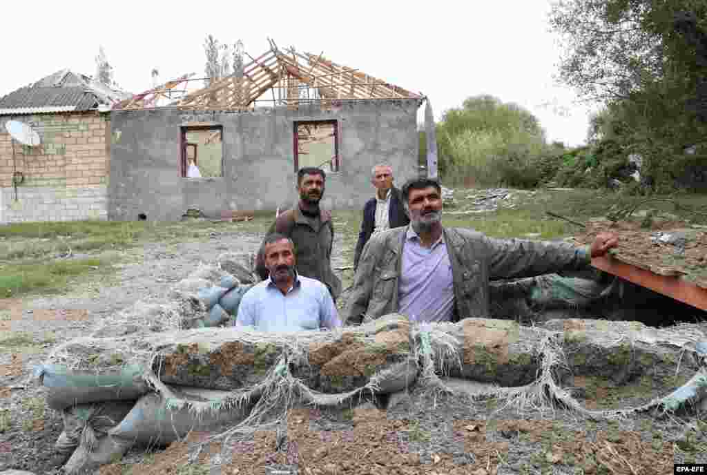 &nbsp;Local residents stand in a pit used as a shelter from shelling on the Azerbaijani town of Tartar, located roughly 20 kilometers north of the breakaway Nagorno-Karabakh region.&nbsp;