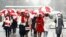 BELARUS -- Women wearing carnival masks march down the streets under umbrellas with the colours of the former white-red-white flag of Belarus to protest against the Belarus presidential election results in Minsk, January 26, 2021