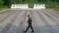 NORTH KOREA  -- A guard walks along a platform past signs, which read "Russia" (L) and "DPRK"(Democratic People's Republic of Korea), at the border crossing between Russia and North Korea in the settlement of Tumangan, North Korea, July 18, 2014