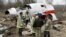 RUSSIA – In this April 13, 2010 file photo, emergency ministry workers stand near the wreckage at the site of the plane crash that killed Polish President Lech Kaczynski in Smolensk. April 13, 2010
