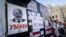 BELARUS – People put anti-Belarusian President Alexander Lukashenko posters on a wall in front of the government building during opposition rally in Minsk, August 16, 2020