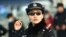 China -- This photo taken on February 5, 2018 shows a police officer wearing a pair of smartglasses with a facial recognition system at Zhengzhou East Railway Station in Zhengzhou in China's central Henan province. Chinese police are sporting high-tech su