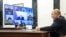 In this pool photograph distributed by the Russian state agency Sputnik, Russia's President Vladimir Putin chairs a meeting with members of the government via videoconference in Moscow on April 23, 2026. (Photo by Alexander KAZAKOV / POOL / AFP)