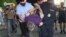 Police detains a protester in Khabarovsk following a brawl with alleged provocateur