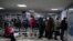 RUSSIA - People wearing protective face masks, used as a preventive measure against the spread of the coronavirus disease (COVID-19), stand in a queue at a local clinic in Omsk, Russia November 9, 2020