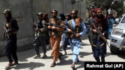Taliban fighters patrol in Kabul's Wazir Akbar Khan neighborhood on August 18, 2021.