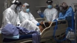 Medical workers prepare to intubate a coronavirus disease (COVID-19) patient at the United Memorial Medical Center's coronavirus disease (COVID-19) intensive care unit in Houston