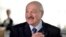 BELARUS -- Belarusian President Alyaksandr Lukashenka reacts as he votes at a polling station during the presidential election in Minsk, August 9, 2020