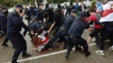 BELARUS -- Belarusian police and OMON officers detain students who march with the opposition flags to show their solidarity with political prisoners in Minsk, September 1, 2020