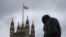 A Union flag flies over the Houses of Parliament in central London